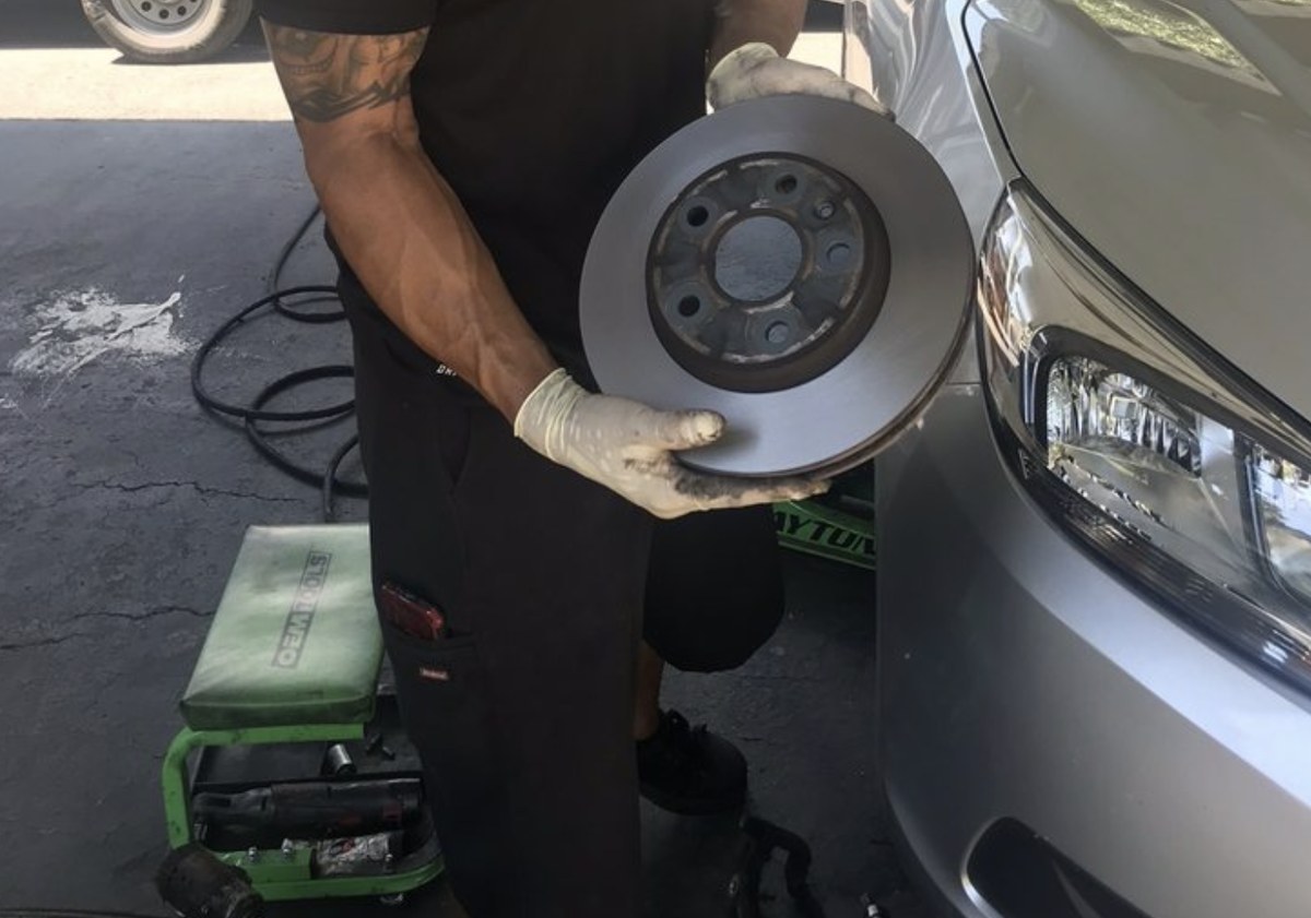 Lubbock mobile mechanic with a fresh rotor at a driveway brake job